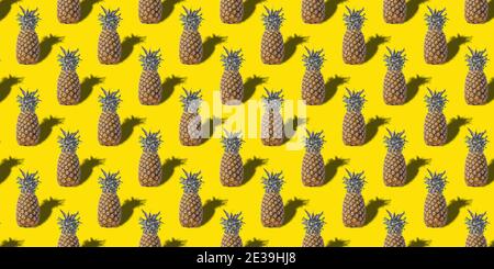 Ripe, juicy pineapple on a yellow isolated background. The concept of healthy eating. Seamless pattern. Original packaging design. Stock Photo