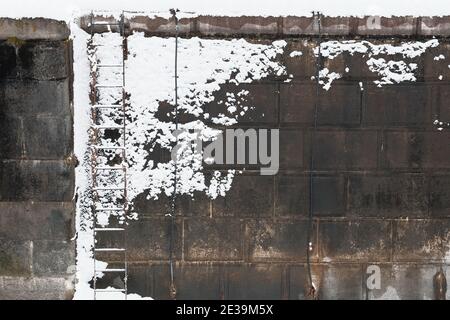 Rideau canal lock wall, emptied for the winter and flecked with snow. Ottawa, Ontario, Canada. Stock Photo