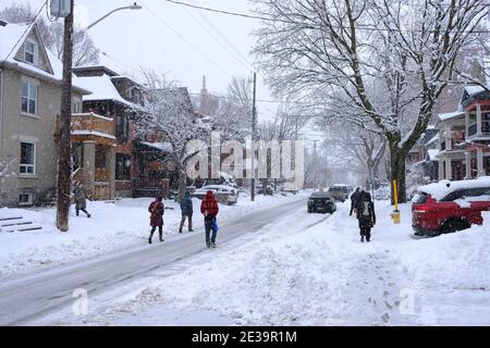 Snowy Ottawa! Scenes from around Ottawa during a fresh dumping of 25cm. Pedestrians walking in the plowed road to avoid the sidewalk. Ontario, Canada. Stock Photo