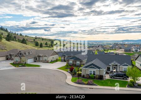 View from a hilltop in Liberty Lake, Washington, of  a newer subdivision of homes with the cities  of Spokane and Spokane Valley. in the distance. Stock Photo