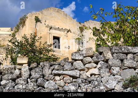 Pigeons sit on an open window in an abandoned building in the ancient sassi area of Matera, Italy. Stock Photo