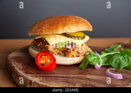 Fresh Pulled pork sandwich with pickled cucumber, arugula and jalapenos Stock Photo