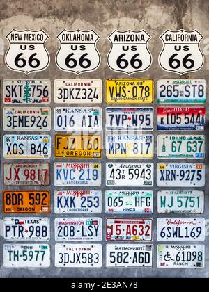 Nakhonsawan, Thailand - January 9, 2021 ; Various old used American license plates decorated on concrete wall, vertical style. Stock Photo