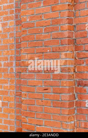 Full frame abstract texture background of an old shabby chic red clay brick wall with grungy bricks showing staining and repaired patch work Stock Photo