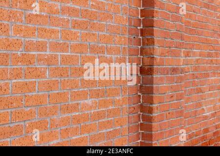Full frame abstract texture background of an old shabby chic red clay brick wall with grungy bricks showing staining and repaired patch work Stock Photo