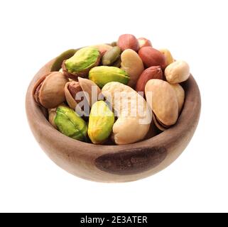 Mix nuts in wooden plate isolated on white backgrounds. Peanut, pumpkin seed, pistachio,cashew. Stock Photo