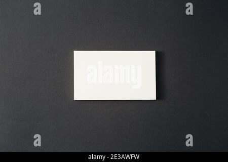 A white rectangular sheet of paper lies on a black background. Stock Photo