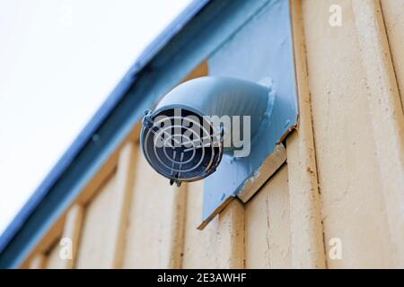 a small fan mounted on the house facade Stock Photo