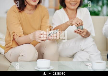 Female friends paying cards Stock Photo