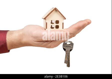 hand holding model house and keys. Close-up of hand holding keys and wooden house model isolated on white background. Mortgage loan approval home loan Stock Photo
