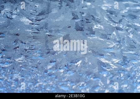 Winter frosty pattern on the glass. A frozen glass at low temperatures on the street. Stock Photo