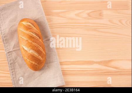 fresh white loaf of bread on wooden table. bakery products on wooden background. Delicious fresh bread. cost or bread recipe concept. copy space. top Stock Photo