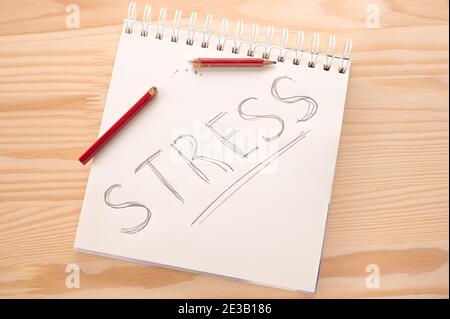 Stress concept. stress relief and management concept. notepad with word stress and broken pencil in madness. Reduce Stress Stock Photo