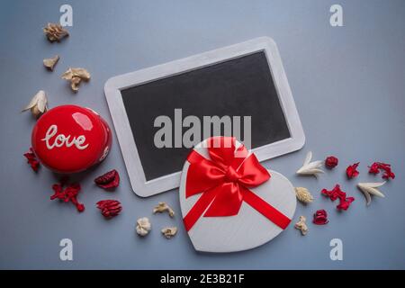 Valentines day greeting card. Heart shaped gift box and chalkboard for your greetings. Flat lay, copy space Stock Photo