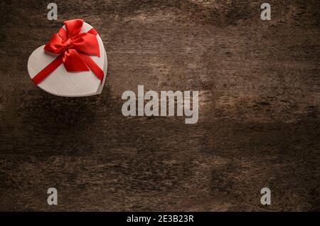 Heart shape gift box over dark background. Top view, copy space Stock Photo