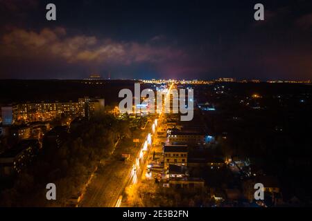 Aerial photo of night car traffic in city. Busy transport road from aerial view. Stock Photo