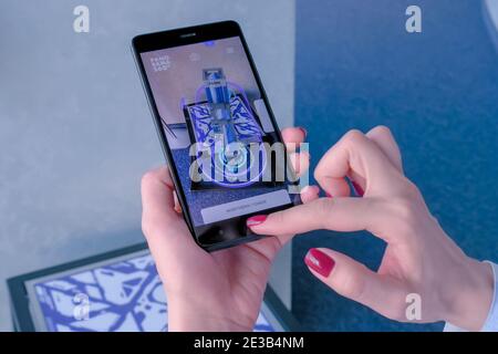 Woman using smartphone with architecture augmented reality app - AR concept Stock Photo