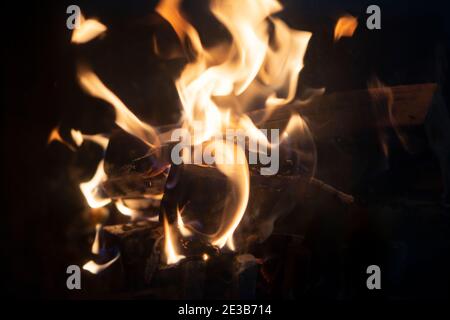 Fire flame background. Firewood burning in the fireplace. Stock Photo