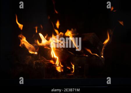 Fire flame background. Firewood burning in the fireplace. Stock Photo