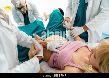 Woman hardly pushing to give child birth, natural labor and delivery Stock Photo