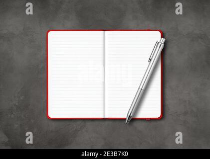 Red open lined notebook mockup with a pen isolated on dark concrete background Stock Photo
