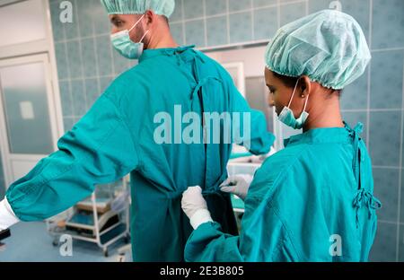 Exhausted surgeons at the emergency room as a sign of stress and overwork Stock Photo