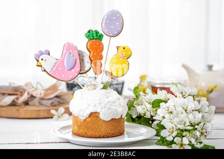 Easter composition with beautifully decorated Easter cake and spring flowers. The concept of preparing for the Easter holiday. Stock Photo