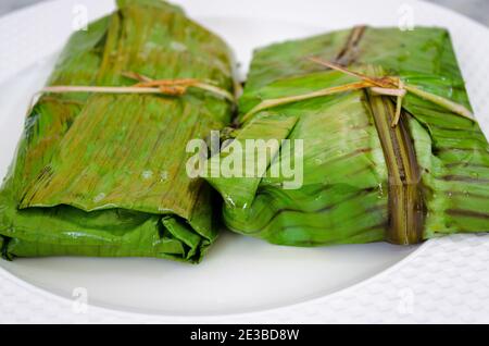 Closeup of fish covered and fried in banana leaf in traditional Kerala style (Meen Pollichathu) Stock Photo