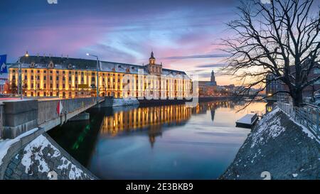 Winter in Wroclaw, Poland. Panoramic cityscape with city skyline reflecting in Oder river on sunset Stock Photo