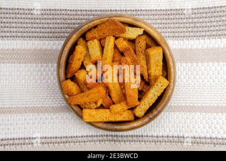 croutons brown pieces of dried bread in bowl. Top view Stock Photo