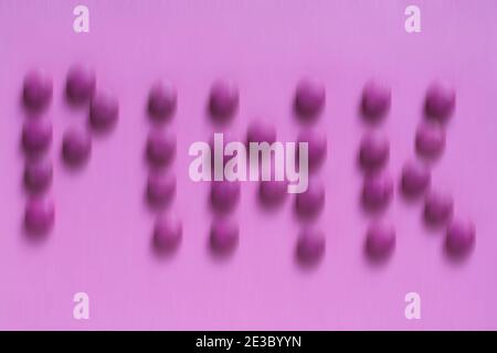 pink purple abstract background - sweets arranged to spell the word pink blurred blur Stock Photo