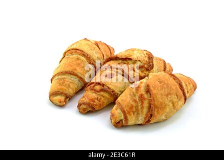 Three cinnamon croissants on white background. Sweet rolls. Mini Desserts with cinnamon. Stock Photo
