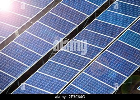 Artistic image of a top down view of rows of solar panels on the roof, with light flare effect, Singapore. Stock Photo
