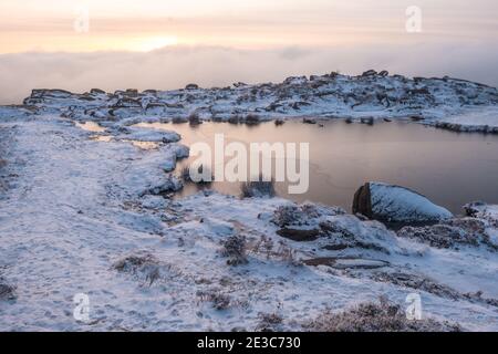 The frozen Doxeys Pool on the Roaches ridge in the Staffordshire Moorlands area of the Peak District National Park, UK Stock Photo