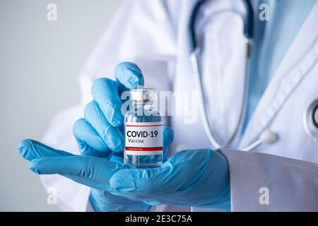 coronavirus COVID-19 vaccine and immunization concept. doctor hand holding vaccine bottle for injection use. corona virus prevent, treatment Stock Photo
