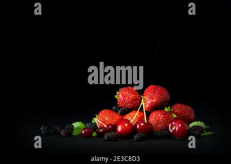 Berries closeup assorted fresh mix colorful arrangement in studio on dark background Stock Photo