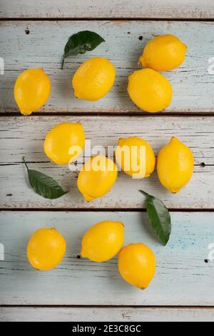 Fresh fragrant lemons on a blue wooden table Stock Photo