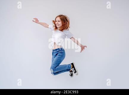 Smiling little girl jumping high Stock Photo