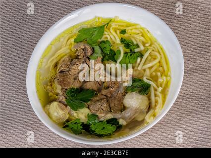 Top view of a plate of homemade soup with meat and noodles Stock Photo