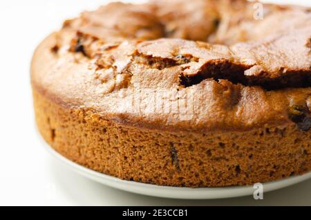 Freshly made spiced fruit ring loaf cake  on the white  background,  traditional British cake Stock Photo