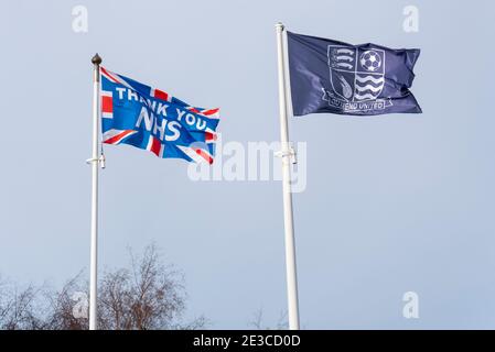 Flags outside Southend Utd football ground at Roots Hall, Southend on Sea, Essex, UK, with thank you NHS during COVID 19 pandemic. Club crest Stock Photo