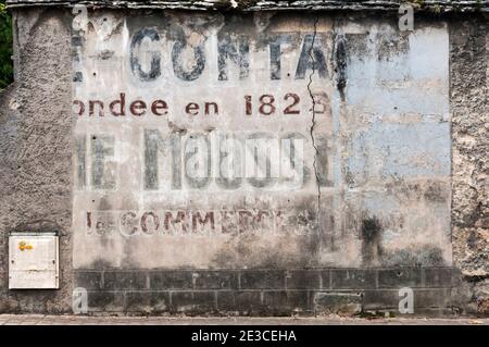 Old ghost sign on the side of a building in Nuits St Georges, France. Stock Photo