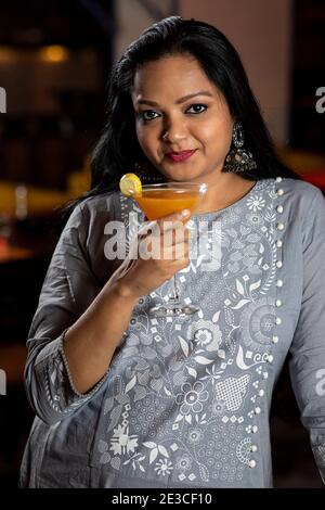 Portrait of an Indian woman holding a glass of juice. Stock Photo