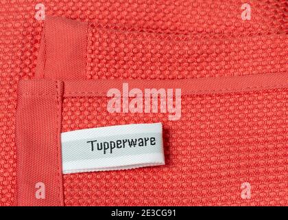 Tupperware logo label on pink microfiber cleaning cloth Tupperware Brands home products. Stock Photo