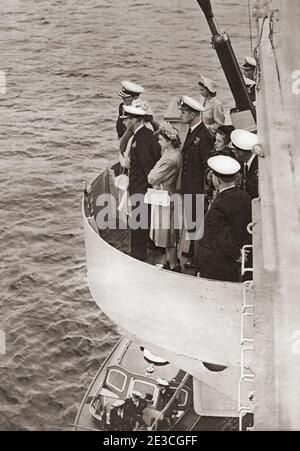 EDITORIAL ONLY Princess Elizabeth of York and Prince Philip, seen here when he was Lieutenant Philip Mountbatten, accompanying her father King George VI on board the H.M.S. Maidstone during an inspection of the Home Fleet in the Clyde.  George VI (Albert Frederick Arthur George),1895 –1952. King of the United Kingdom and the Dominions of the British Commonwealth.  Princess Elizabeth of York, future Elizabeth II,1926 - 2022.  Queen of the United Kingdom.  Prince Philip, born Prince Philip of Greece and Denmark, 1921. Husband of Queen Elizabeth II of the United Kingdom.  From The Queen Elizabeth