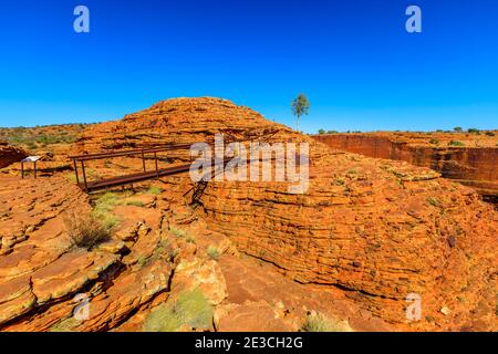 Scenic landscape of Kings Canyon North wall and high vertical rock behind Cotteril's Bridge which crosses a deep crevice in Watarrka National Park Stock Photo