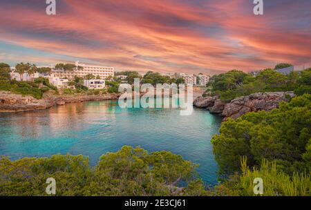 Panorama of the famous Cala d’Or region and Esmeralda beach illuminated at sunset in summertime, Palme de Mallorca - Spain Stock Photo