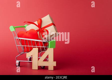 Hearts in shopping push cart on yellow background, sales and love ...