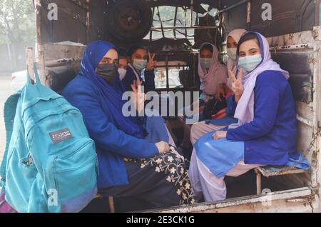 Lahore, Pakistan. 18th Jan, 2021. Pakistani students wearing face masks coming out after attending their first day of school at Kinnaird government school in Lahore. Pakistani government reopened educational institutes across the country from grade 9th to 12th after remaining closed as a preventive measure against the Covid-19 coronavirus. Pakistani authorities started to reopen schools in phases despite a steady increase in deaths and infections from the coronavirus, official said. (Photo by Rana Sajid Hussain/Pacific Press) Credit: Pacific Press Media Production Corp./Alamy Live News Stock Photo