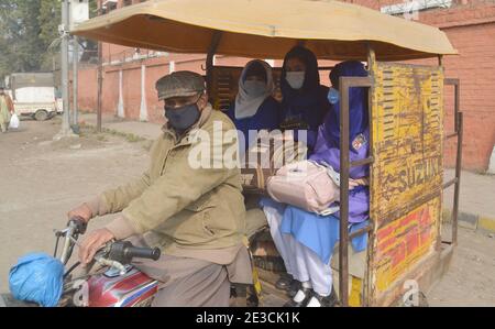 Lahore, Pakistan. 18th Jan, 2021. Pakistani students wearing face masks coming out after attending their first day of school at Kinnaird government school in Lahore. Pakistani government reopened educational institutes across the country from grade 9th to 12th after remaining closed as a preventive measure against the Covid-19 coronavirus. Pakistani authorities started to reopen schools in phases despite a steady increase in deaths and infections from the coronavirus, official said. (Photo by Rana Sajid Hussain/Pacific Press) Credit: Pacific Press Media Production Corp./Alamy Live News Stock Photo